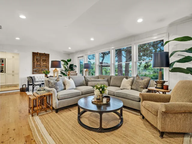 a living room with furniture and large windows