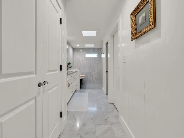 a bedroom with a large bed and wooden floor