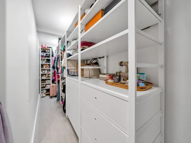 a bathroom with a granite countertop toilet sink and mirror