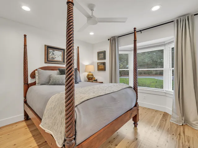 a view of a patio with table and chairs with wooden floor and fence