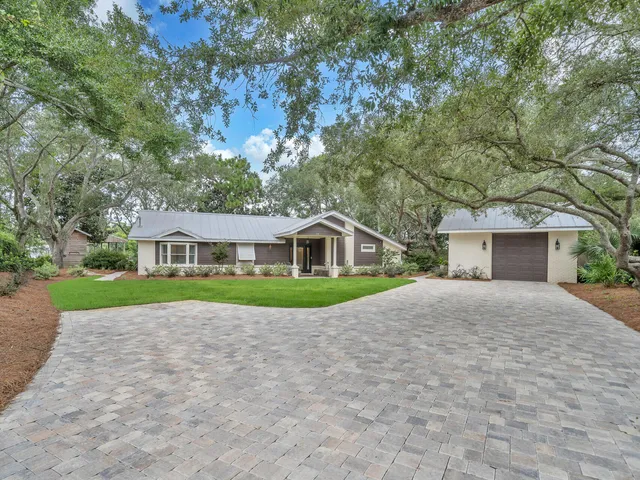 a view of a house with a yard and tree