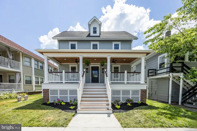a front view of a residential apartment building with a yard