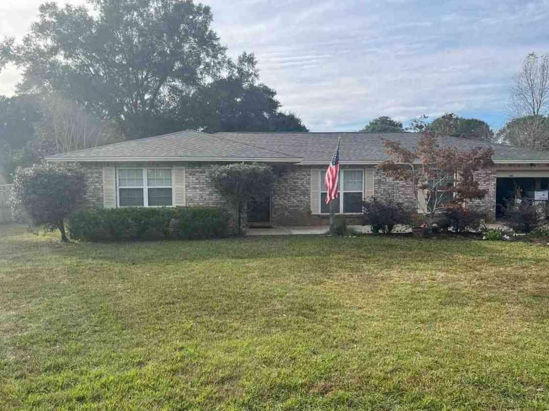 a front view of a house with a garden