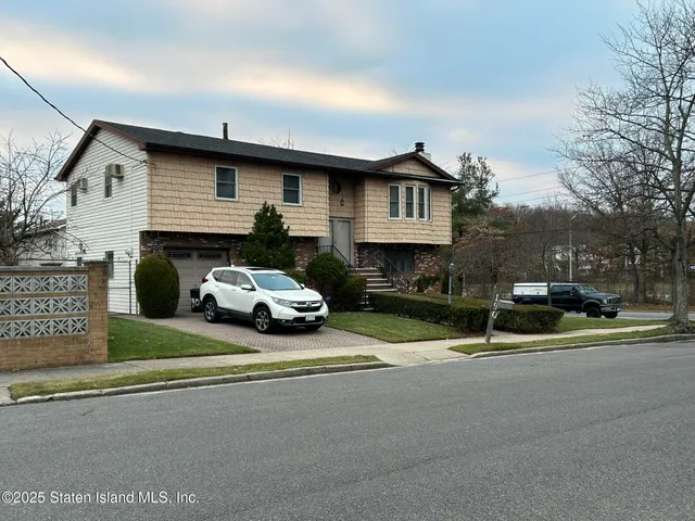 a view of a car park in front of house