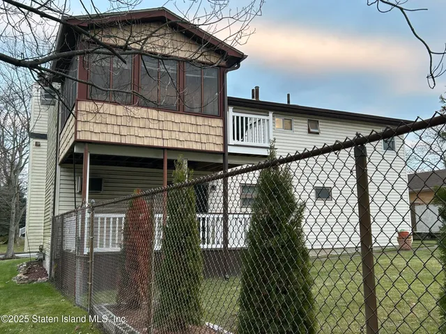 a view of a house with a wooden deck