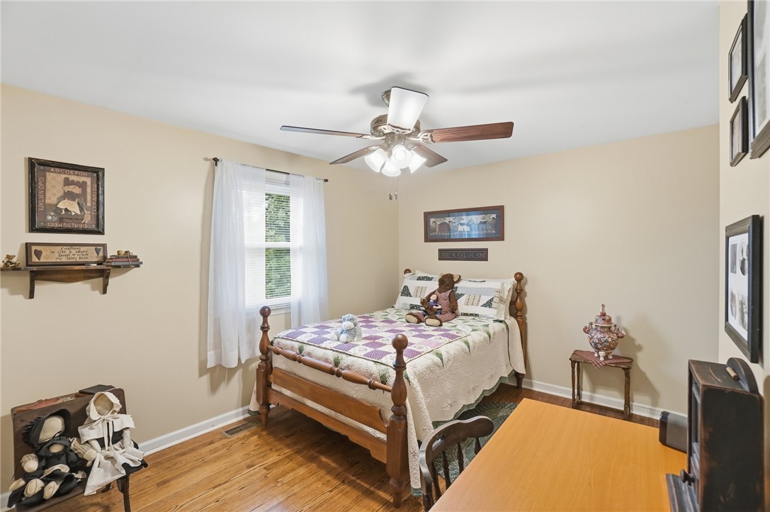 4170 Johnson Road Springfield, OH 45502 - Photo 43 of 54 Hardwood floors and a bright window frame this inviting, comfortable bedroom.