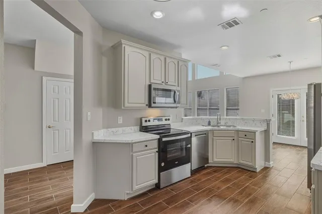 a kitchen with a sink stove and cabinets