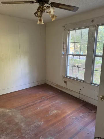 an empty room with a empty space and large windows