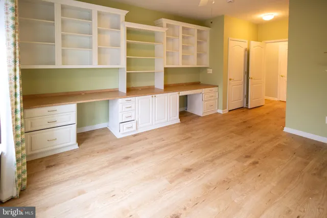 a kitchen with a refrigerator and more cabinets