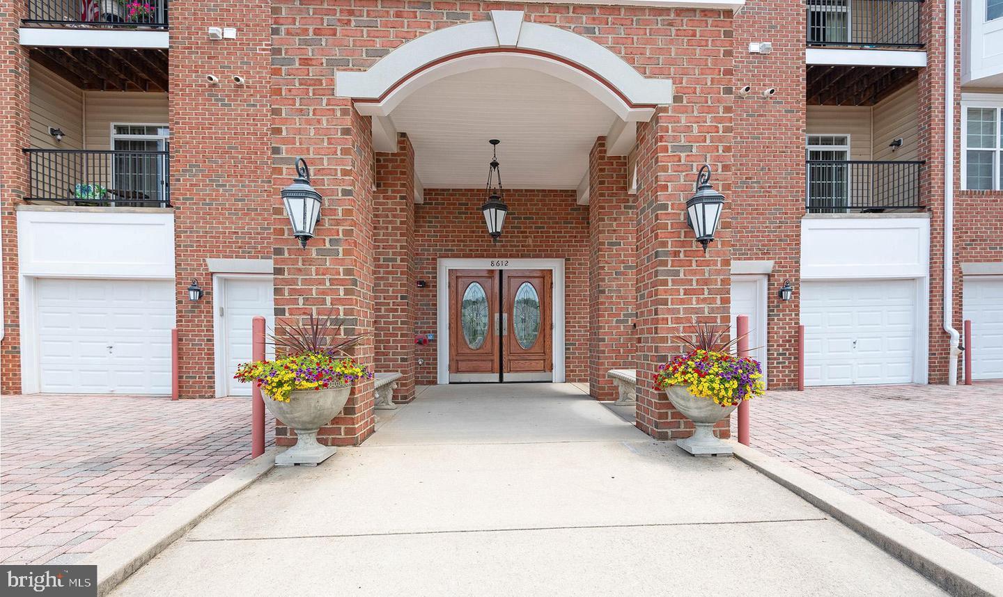 8612 Fluttering Leaf Trail, Unit 404 Odenton, MD 21113 - Photo 2 of 27 a front view of a house with a porch