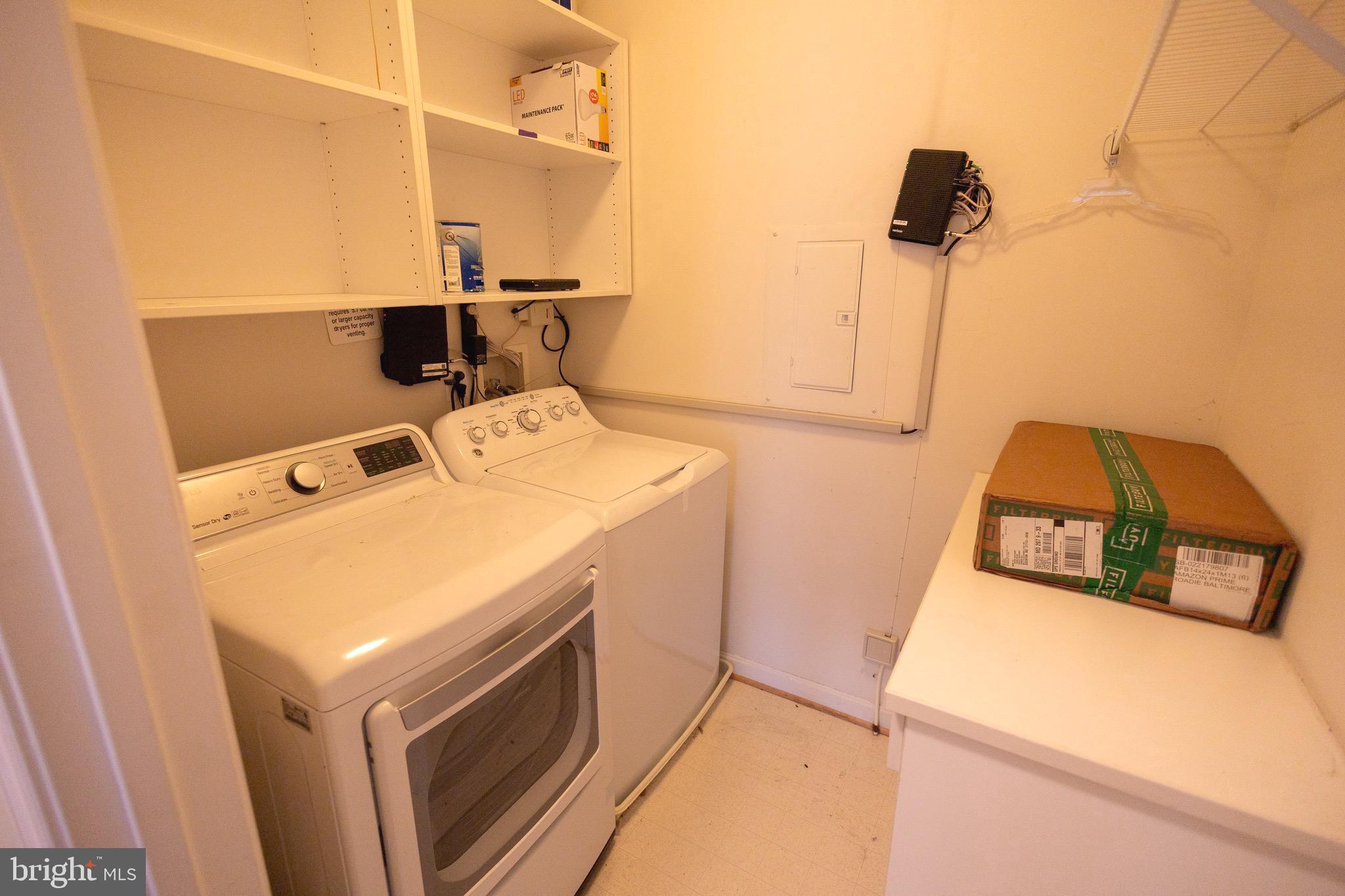 8612 Fluttering Leaf Trail, Unit 404 Odenton, MD 21113 - Photo 21 of 27 a utility room with dryer and washer