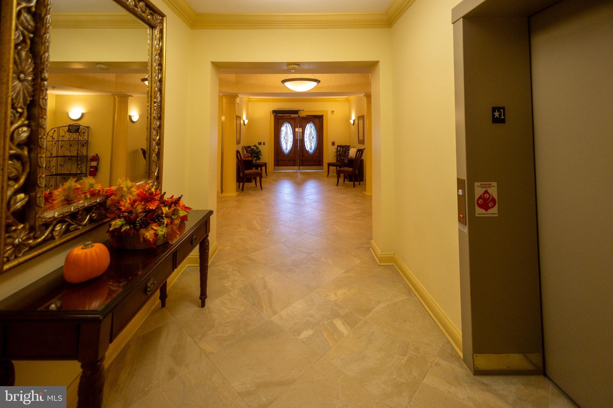 8612 Fluttering Leaf Trail, Unit 404 Odenton, MD 21113 - Photo 22 of 27 a hallway with kids room with couch