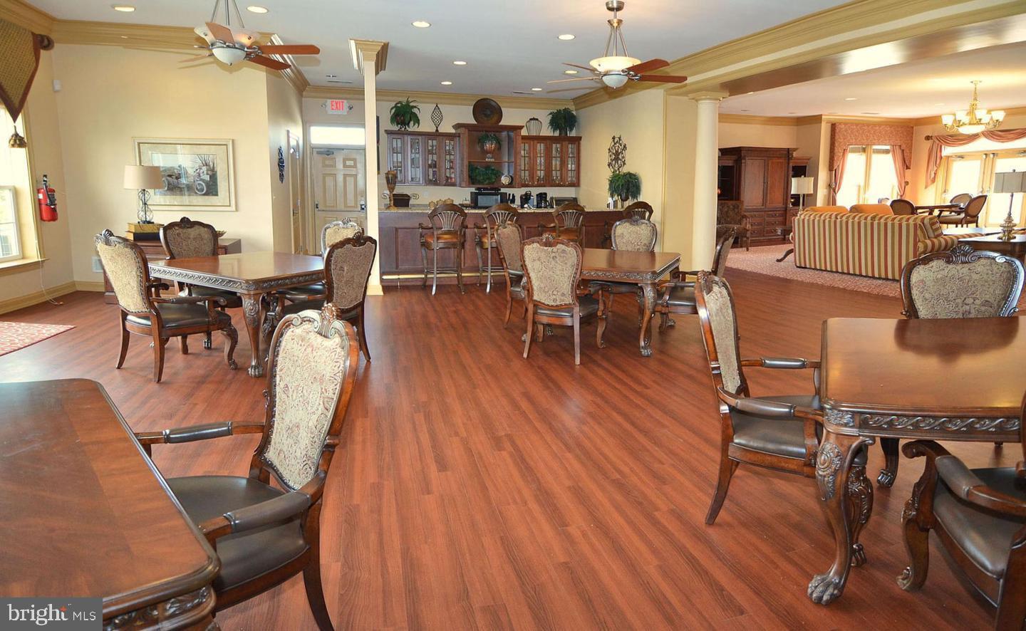 8612 Fluttering Leaf Trail, Unit 404 Odenton, MD 21113 - Photo 27 of 27 a view of a dining room with furniture and wooden floor