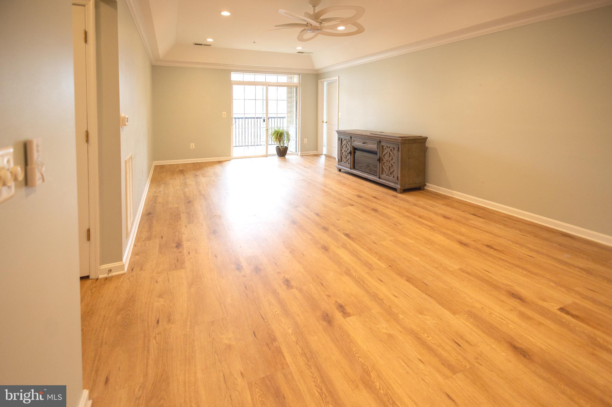 8612 Fluttering Leaf Trail, Unit 404 Odenton, MD 21113 - Photo 8 of 27 a view of an empty room and a kitchen