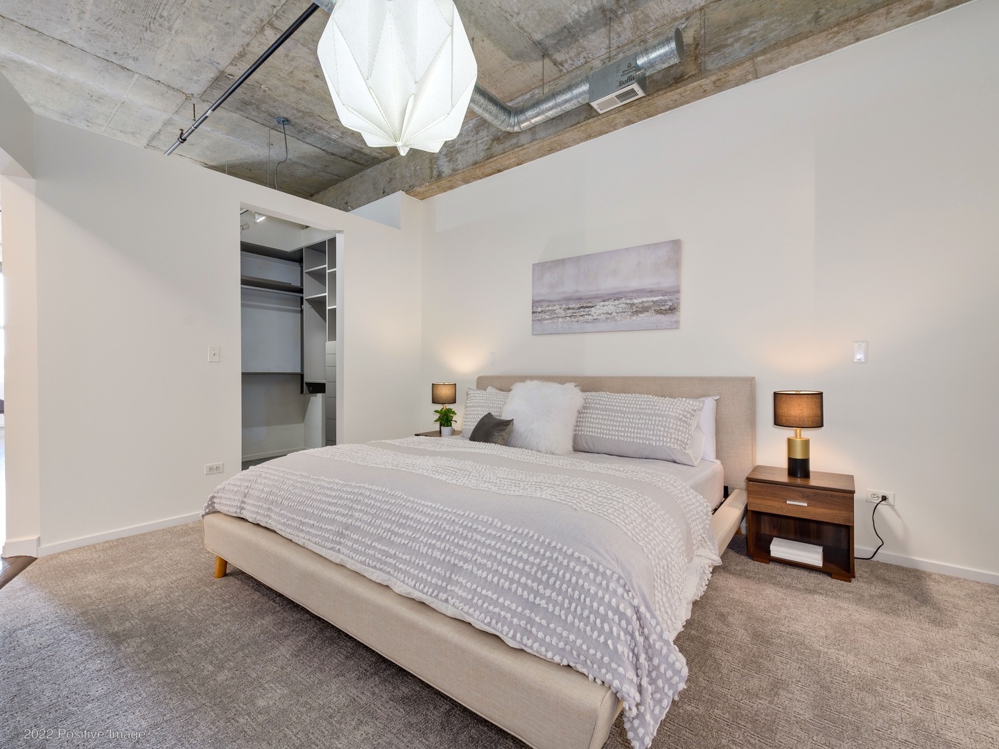 1000 West Adams Street, Unit 613 Chicago, IL 60607 - Photo 14 of 26 a bedroom with a bed and a chandelier