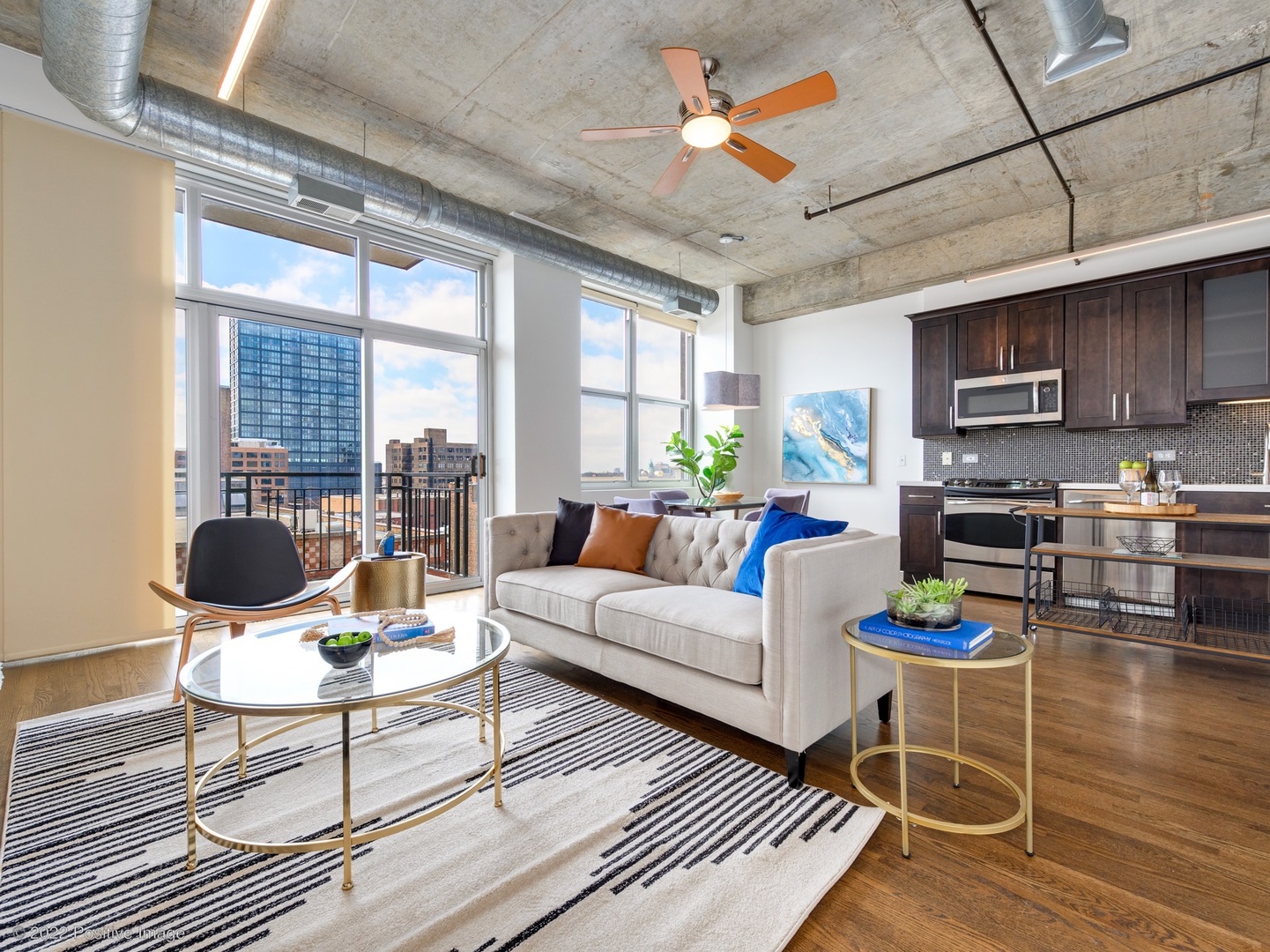 1000 West Adams Street, Unit 613 Chicago, IL 60607 - Photo 2 of 26 a living room with furniture a fireplace and a dining table with kitchen view