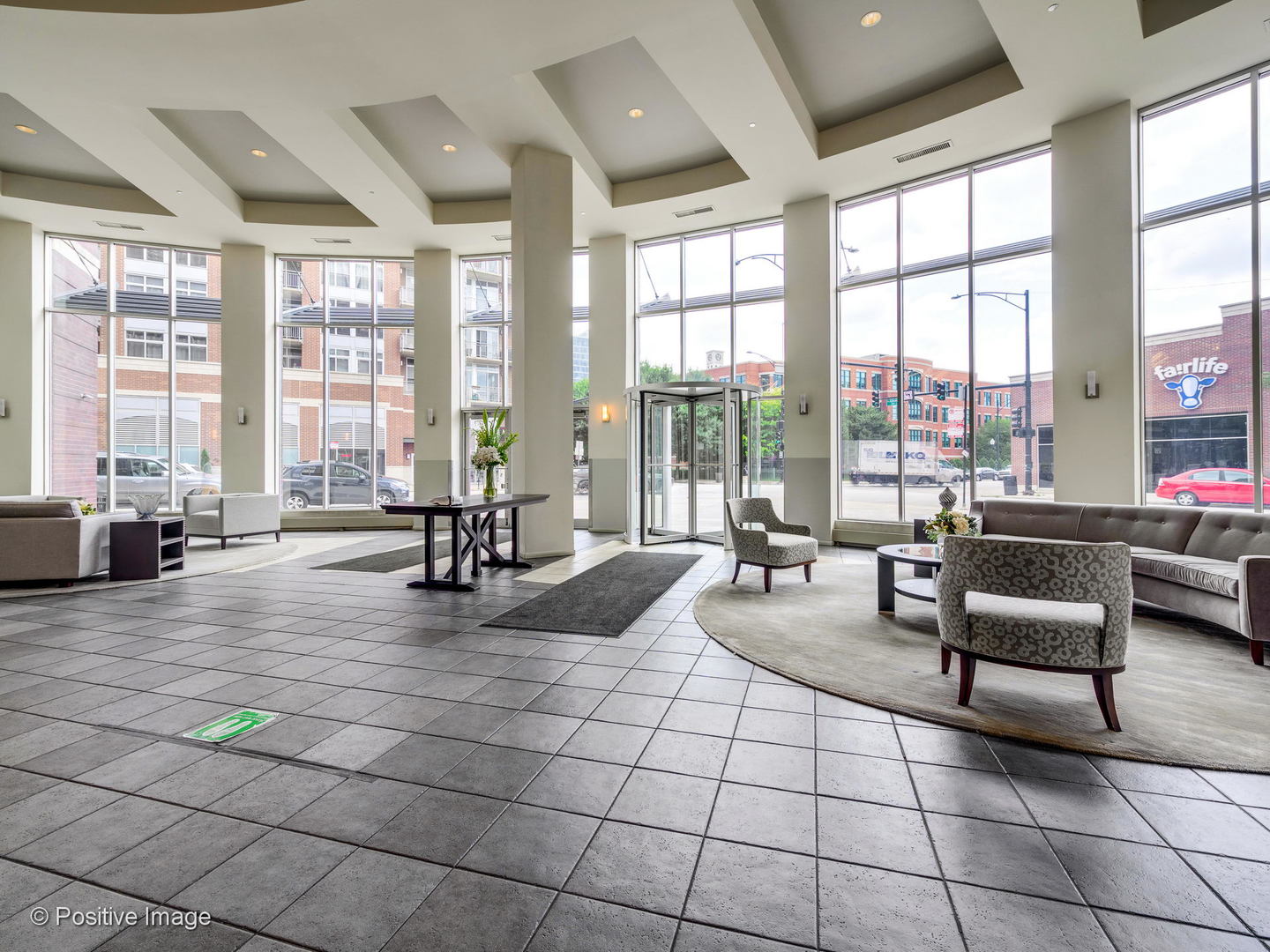 1000 West Adams Street, Unit 613 Chicago, IL 60607 - Photo 22 of 26 a living room filled with furniture and floor to ceiling windows