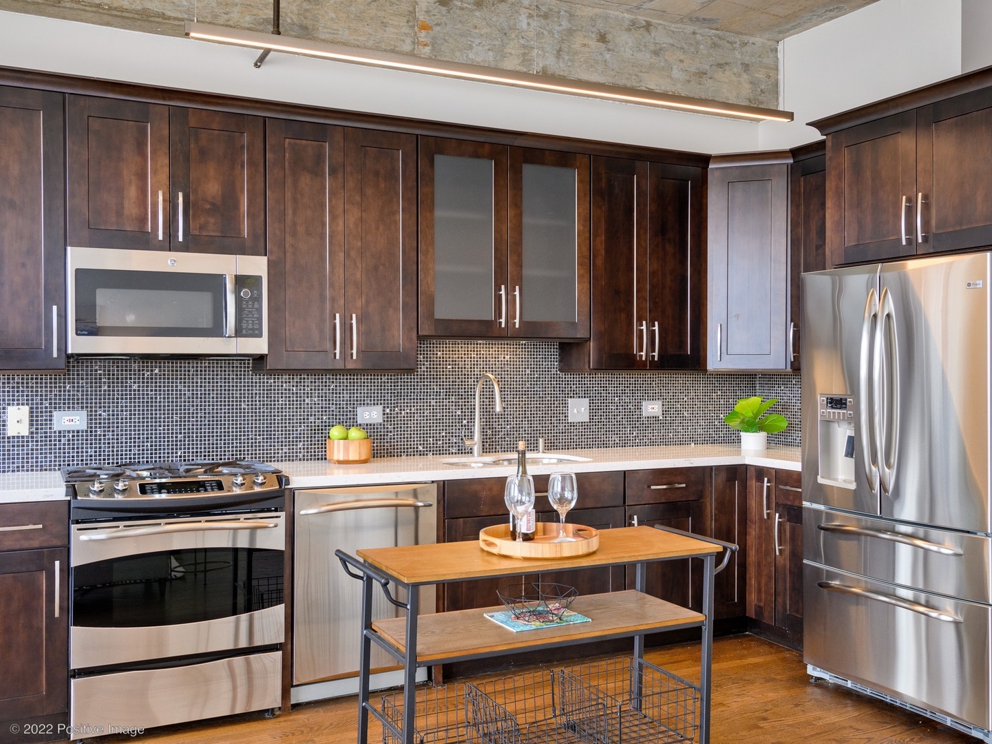 1000 West Adams Street, Unit 613 Chicago, IL 60607 - Photo 7 of 26 a kitchen with stainless steel appliances a stove a microwave and a refrigerator