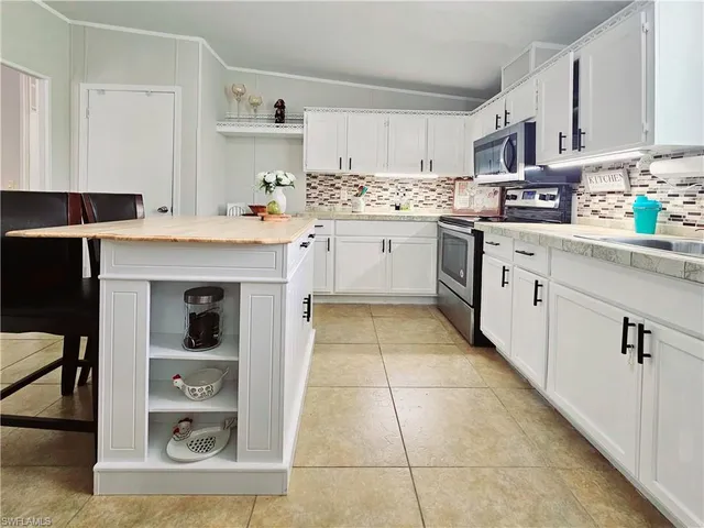 a kitchen with stainless steel appliances granite countertop a sink and cabinets