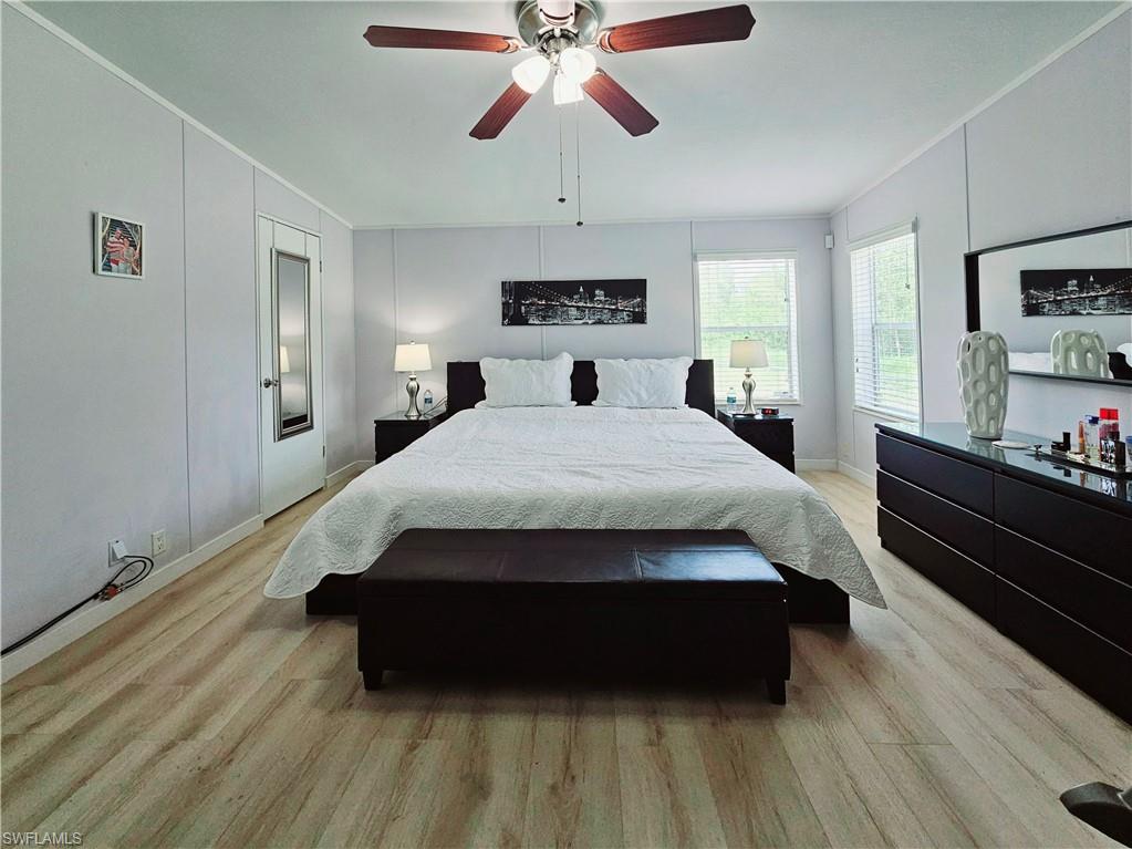 330 F Road LaBelle, FL 33935 - Photo 24 of 35 a bedroom with a bed and wooden floor