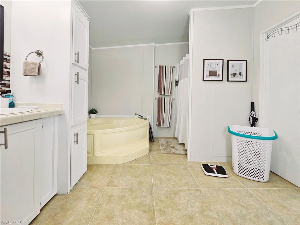 330 F Road LaBelle, FL 33935 - Photo 26 of 35 a bathroom with a tub sink and mirror