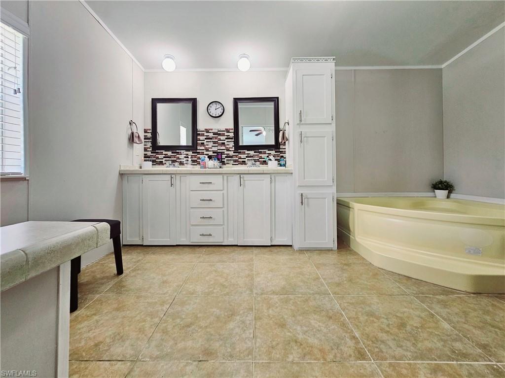 330 F Road LaBelle, FL 33935 - Photo 27 of 35 a bathroom with a sink and a mirror