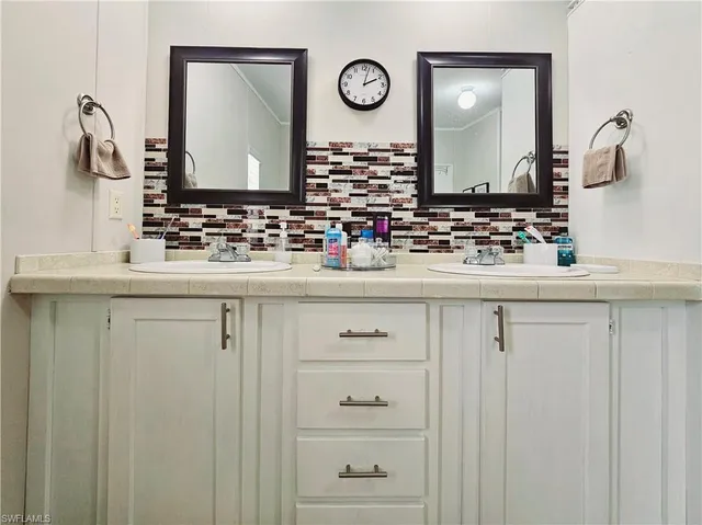 a bathroom with a sink vanity and a mirror