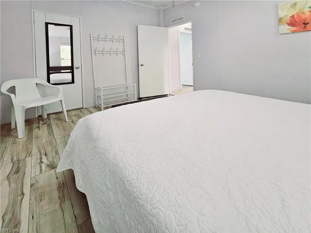 a bedroom with a bed and a table