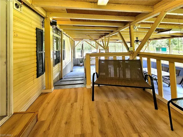 a view of outdoor space with wooden floor and windows