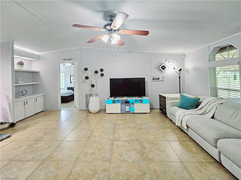 330 F Road LaBelle, FL 33935 - Photo 9 of 35 a living room with furniture and a flat screen tv