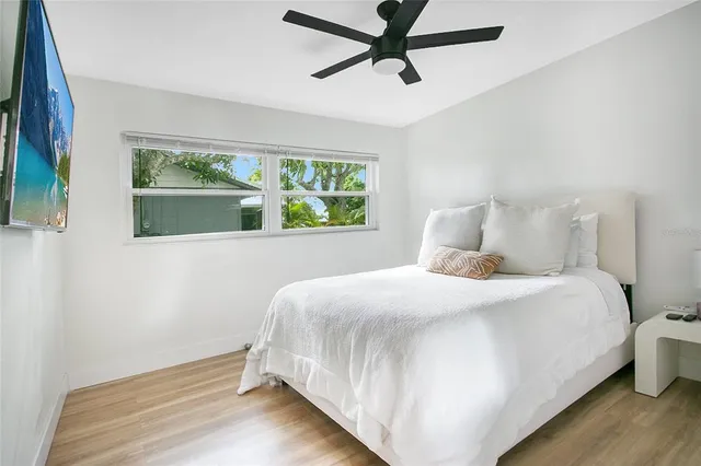 a bedroom with a bed and a window