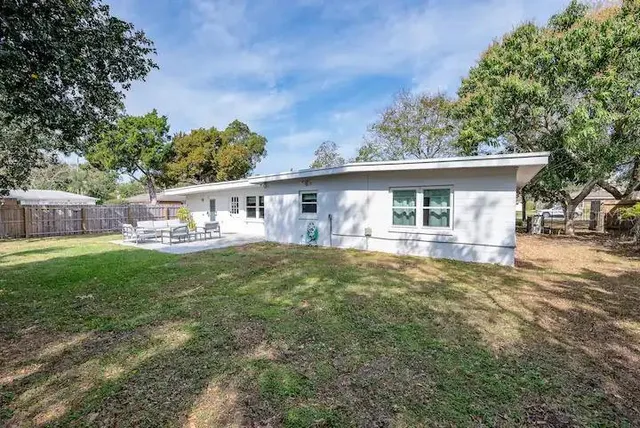 a view of a house with a backyard