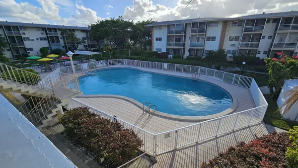 a view of a swimming pool with outdoor seating