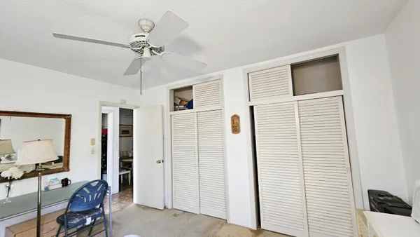 a view of a livingroom with furniture and chandelier fan