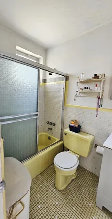 a bathroom with a granite countertop toilet sink and shower