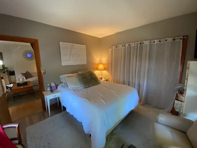 a bedroom with a bed and a mirror