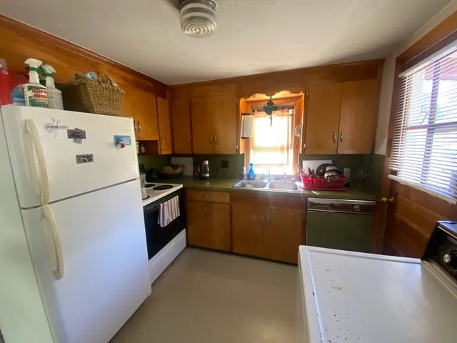 a white refrigerator freezer sitting inside of a kitchen