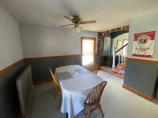 a view of a dining room with furniture and a chandelier