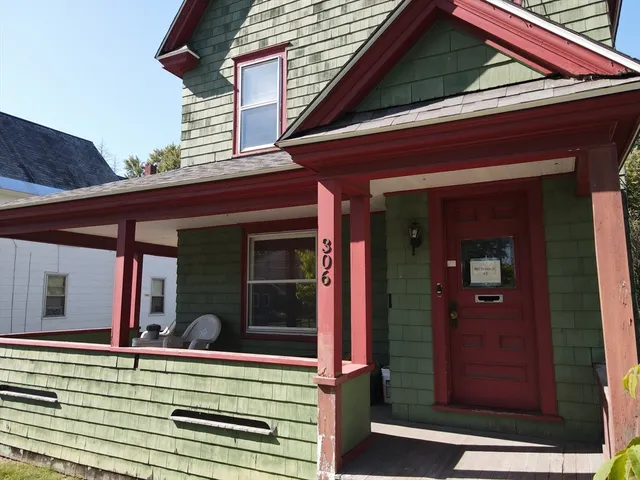 a view of a bedroom with a balcony and furniture