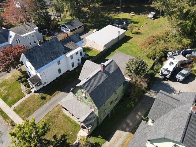 an aerial view of a house with a yard