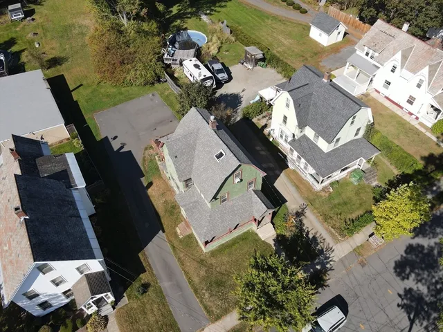 an aerial view of a house with a yard