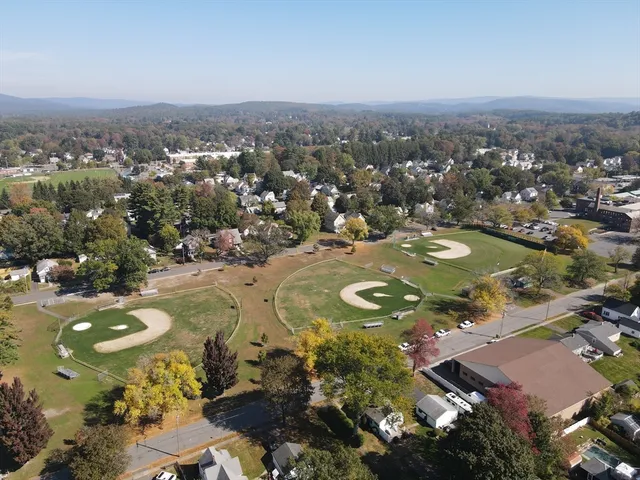 an aerial view of a residential houses with outdoor space