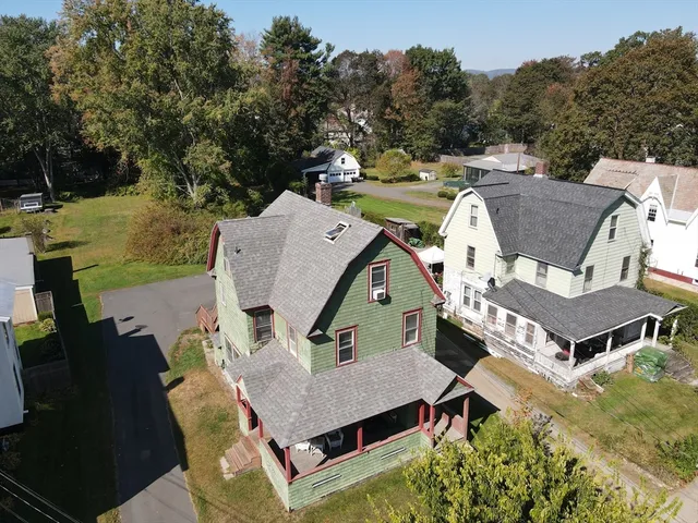 an aerial view of a house with swimming pool and big yard