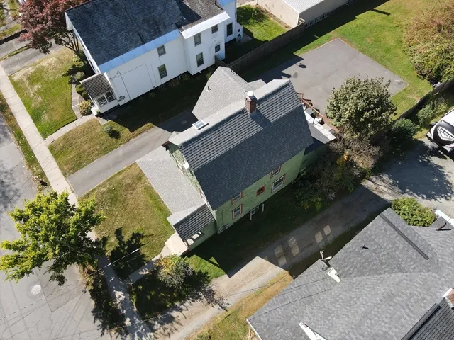 an aerial view of a house with a yard