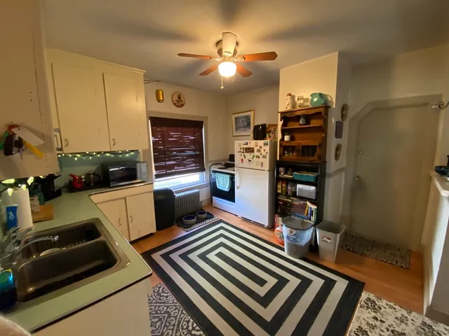 a kitchen with stainless steel appliances a stove a refrigerator and cabinets