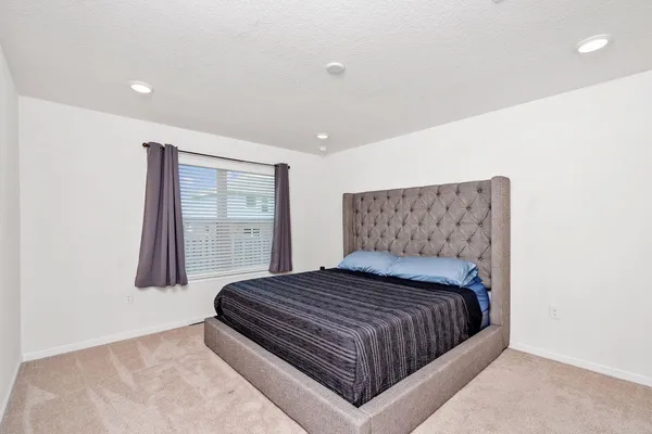 a bedroom with a bed and window