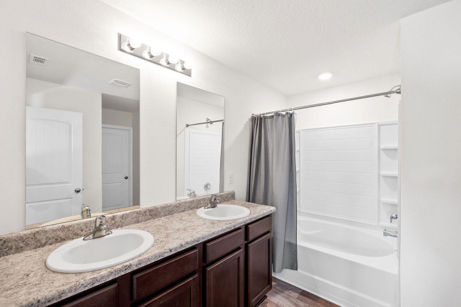 816 Moorhen Way Crestview, FL 32539 - Photo 15 of 19 a bathroom with a granite countertop sink mirror and a bathtub
