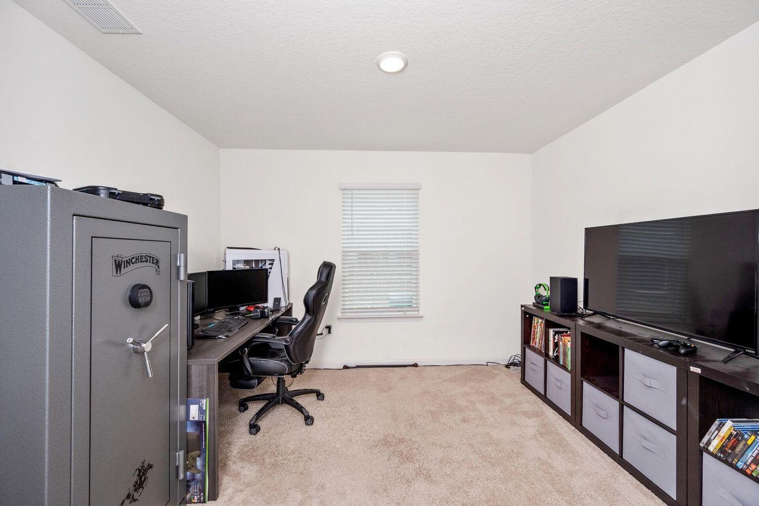 816 Moorhen Way Crestview, FL 32539 - Photo 16 of 19 a view of a workspace with furniture and a flat screen tv