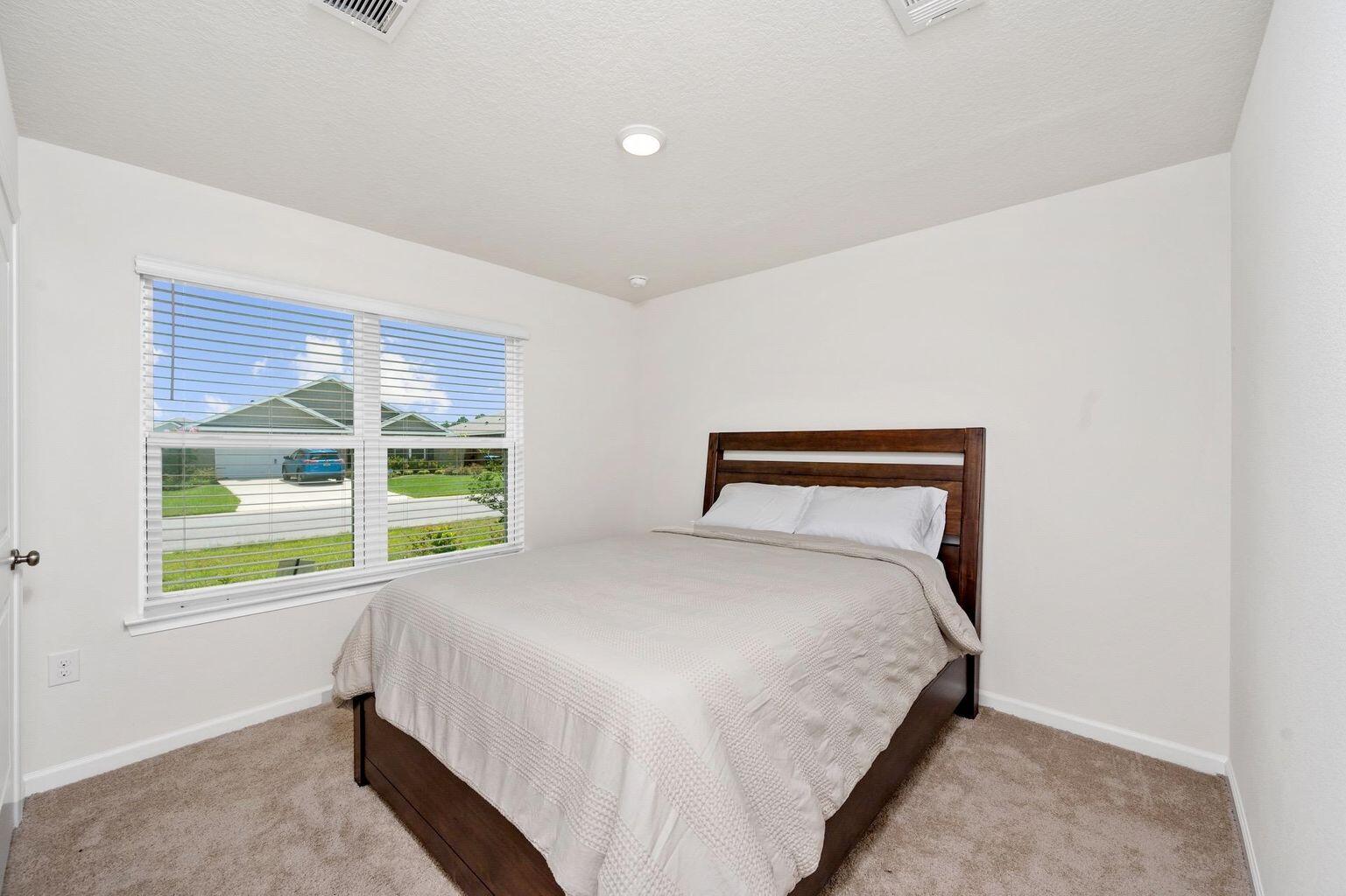 816 Moorhen Way Crestview, FL 32539 - Photo 17 of 19 a bed sitting in a bedroom next to a window