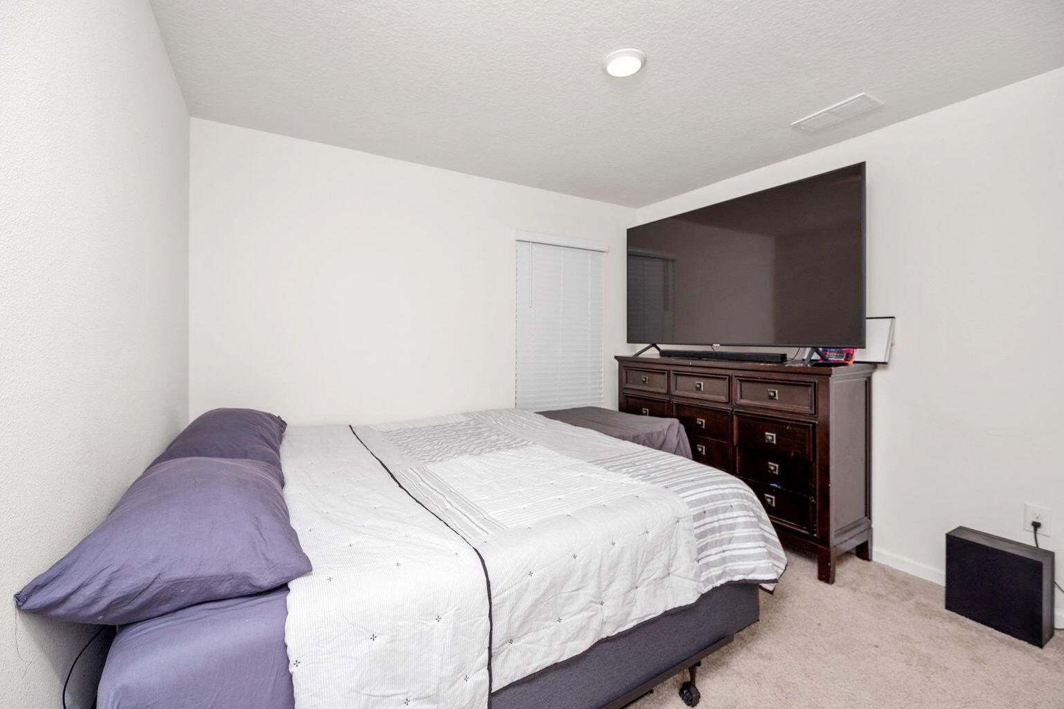 816 Moorhen Way Crestview, FL 32539 - Photo 19 of 19 a bedroom with a bed and a flat screen tv